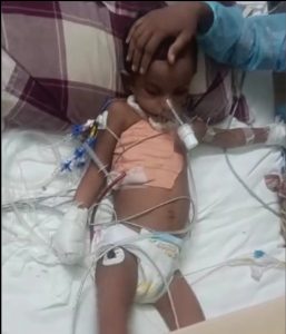 A child lying on a hospital bed