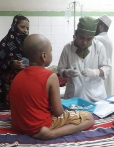 A nurse taking care of a little boy.